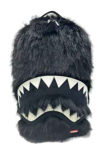 Black furry backpack with shark mouth design on a white background