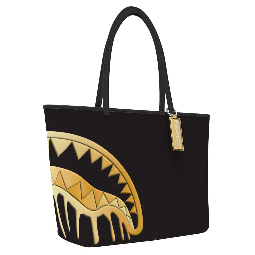 Black tote bag with gold shark mouth design on a white background