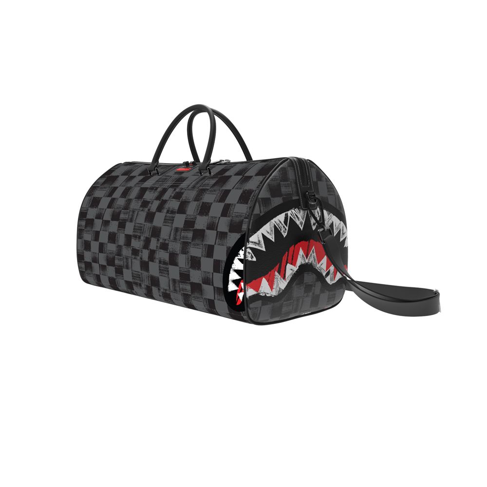 Checkered duffel bag with a shark mouth design on a white background